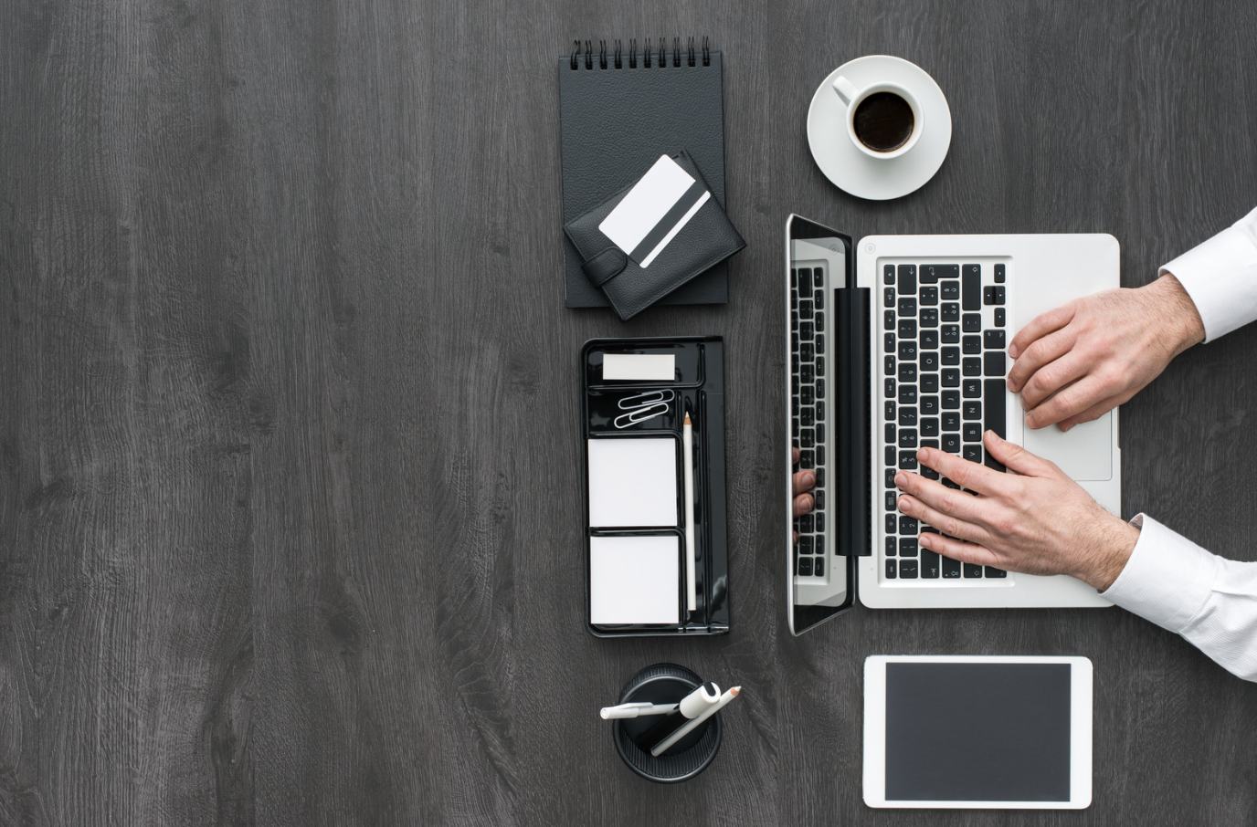 Actuarial consulting workspace with a laptop, reports and calculation tools